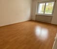 empty room, wooden floor, white walls, large window, radiators