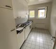 modern kitchen, white tiles, stainless steel sink, oven, dishwasher, white cabinets, two windows