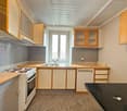 kitchen, stove, sink, dishwasher, cabinets, white walls, carpet