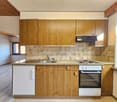 kitchen with wooden cabinets, tiled backsplash, gas stove, sink, dishwasher, electric oven