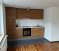 kitchen with wooden cabinets, white counter tops, gas stove, oven, sink, ceiling light