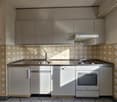 modern kitchen, stainless steel countertops, tiled backsplash, built-in oven, dishwasher, sink with faucet, wooden cabinets, granite countertop, appliances including refrigerator, dishwasher, and stove