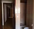 Bathroom with toilet, shower, and wooden floors