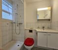 Bathroom with shower, bathtub, toilet, sink, mirror, and cabinets