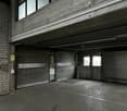 underground parking lot, brick walls, metal shutters, windows, electrical boxes