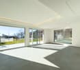 Empty room with large windows, sliding doors, modern ceiling design, tiled floor