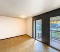 white walls, wooden parquet flooring, sliding doors to balcony, air conditioner