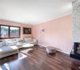 wooden floor, pink walls, sofa, coffee table, floor lamp, fireplace, painting