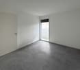 Empty room, white walls, glass sliding door, tiled floor