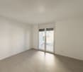 Empty room, sliding door leading to a terrace, tiled floor, white walls, power outlets