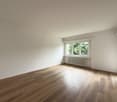 empty room, white walls, wooden floors, white radiator, window