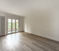 large sliding doors, balcony, white walls, wooden floor, radiator
