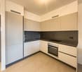white cabinets, tile flooring, stainless steel sink, modern appliances