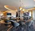 modern interior, glass table, chairs with leather seats, black sofa, fish tank, tv, lamps