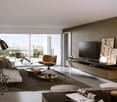 modern living room with white walls, large windows, glass doors leading to a balcony, white couch, brown armchair, wooden coffee tables, floor lamp, flat screen TV, wooden entertainment unit, artwork, rug
