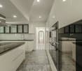 modern kitchen, granite countertops, under cabinet lighting, stainless steel appliances, white cabinets