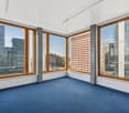 spacious room, large windows, blue carpet, open view to city