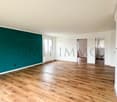empty room, wooden floor, white walls, green accent wall, windows, doors