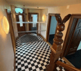 black and white checkered floor, wooden bannister, glass wall, illuminated walls