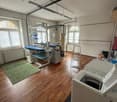empty room with a washing machine, carpet, ironing machine, ladder, wooden floor