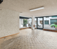 empty room, parquet floor, large windows, double doors, view of a street
