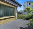 Metal fencing, brick wall, terrace, glass window, metal grate