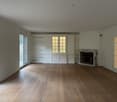 wooden floor, fireplace, sliding glass doors, cabinets, white walls