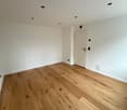 empty room, white walls, wooden floor, white door, recessed lighting
