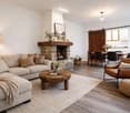 Fireplace, sofa, coffee table, rug, lamp, dining table, chairs, kitchen
