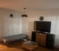 foldable bed, television, coffee table, entertainment center, clocks on wall
