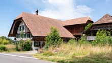 Traditional wooden house, brown roof, green windows, white walls, chimney, balcony