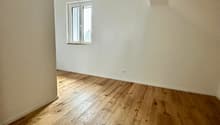 wooden floor, sloped ceiling, power outlet, glass window