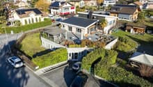 Modern architectural design, rooftop terrace, several parking spaces, green surroundings