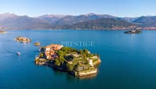 Villa on an island, surrounded by water, mountains in the background