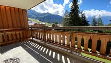 wooden railing, concrete floor, clear view of mountains