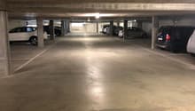 underground parking lot with several cars parked