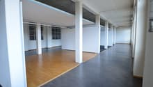 empty office room, wooden floors, gray floors, white walls, pillars, windows