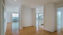 empty room, wooden floor, white walls, large windows, balcony, view