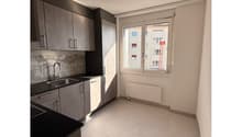 modern kitchen, white tiles, black countertops, stainless steel sink, cabinets, window