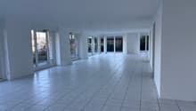 empty room, white walls, glass doors, glass windows, tiled floor, view of outside