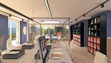 Open office with multiple desks, two computer screens on each desk, modern office chairs, bookshelves, glass walls, large windows