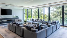 U-shaped sofa with coffee table, TV, floor to ceiling windows