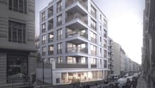 multistory building, balconies on each floor, white exterior, modern design, ground floor entrance