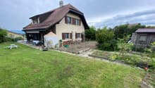 2 story house, brown roof, beige walls, large garden, patio, shed