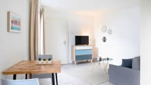 Minimalist design, wooden table, sofa, TV on cabinet, framed art, rug
