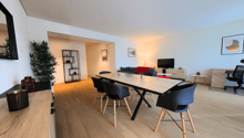 dining area with table and chairs, plant, mirror, TV, couch, shelves, office chair
