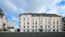 5 story building, beige facade, multiple windows, modern architecture