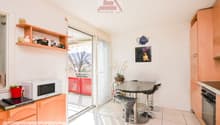 white wall, white floor, wooden cabinet, glass door, table and chair, balcony, microwave, potted plant
