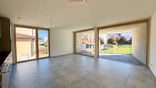 large room, gray tile floor, sliding glass doors leading to a balcony
