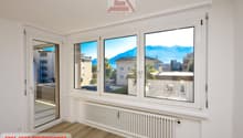 Empty room, large windows, mountain view, white wall, wooden floor